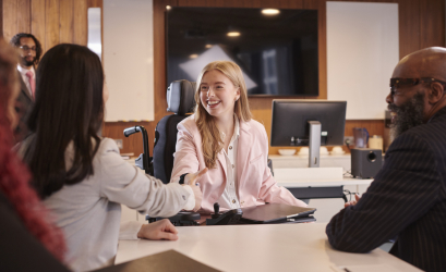 3 people having a conversation, one of them is a wheelchair user